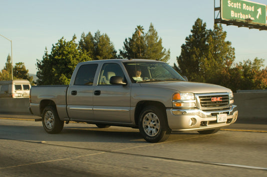 Silver pickup truck driving on a highway