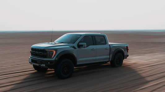 A truck is driving through the desert
